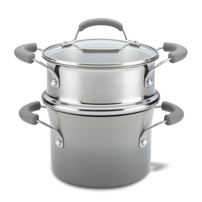 The 3-Quart Classic Brights Nonstick Covered Steamer Set features a stainless steel saucepot with a glass lid and grey handles, ideal for steaming vegetables or creating the perfect pasta dish.