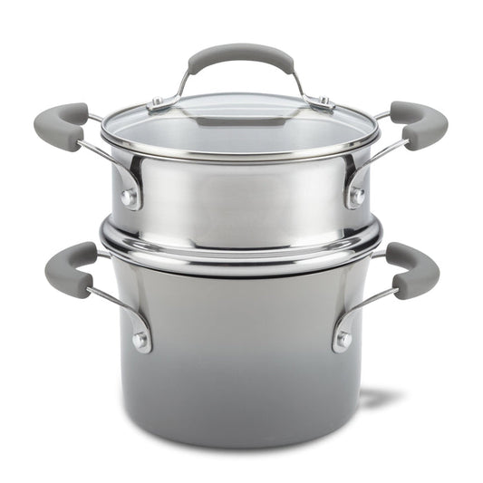 The 3-Quart Classic Brights Nonstick Covered Steamer Set features a stainless steel saucepot with a glass lid and grey handles, ideal for steaming vegetables or creating the perfect pasta dish.