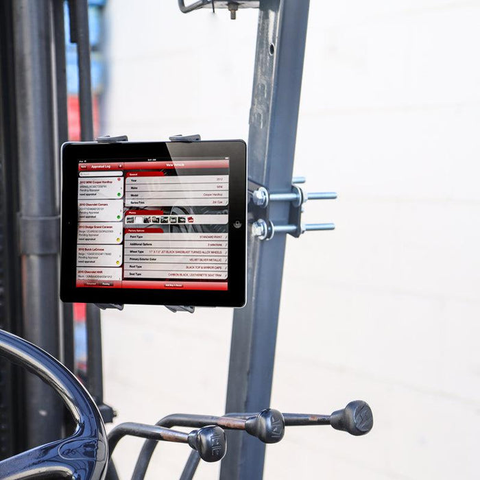 A 7 inch Robust Forklift Front Guard Slim-Grip® Tablet Mount is attached to industrial equipment, showing a technical interface with red and white menus. Metal levers appear below the tablet, with a blurred background.