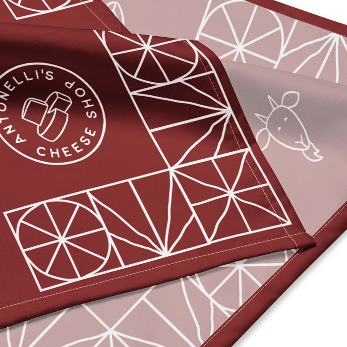 All-over print bandana with geometric design and cheese shop logo.