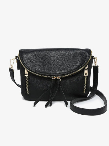 Black pebbled faux-leather crossbody bag with gold-tone hardware, a front zip closure, and a tassel detail, shown on a light gray background.