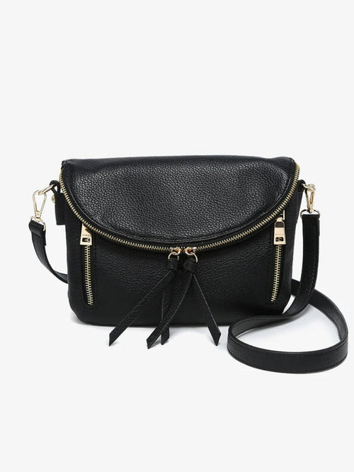 Black pebbled faux-leather crossbody bag with gold-tone hardware, a front zip closure, and a tassel detail, shown on a light gray background.