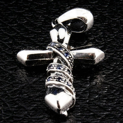 Full pendant view resting on a black textured background, highlighting the polished silver bail and blue stone chain wrap.