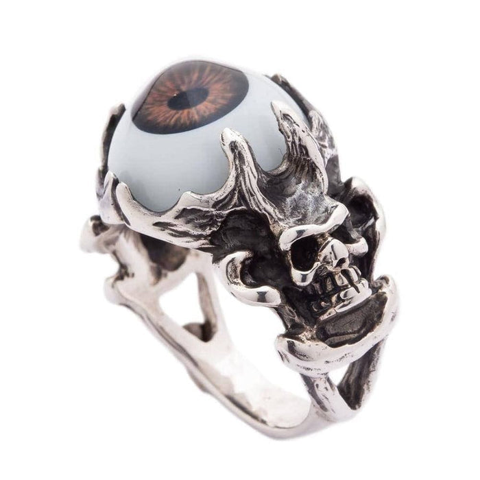 Front view of the men's gothic devil skull ring, showing the 925 sterling silver skull face holding a brown eyeball.
