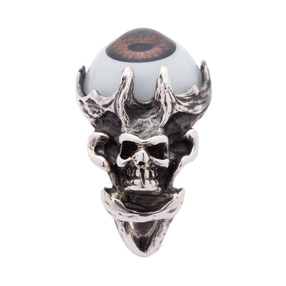 A side profile of the handcrafted silver skull ring, showing the bony band and the brown eyeball setting.