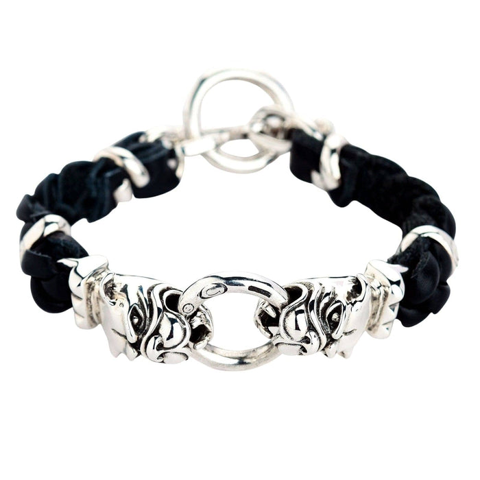 A close-up of the two detailed sterling silver bulldog heads on the men's leather bracelet.