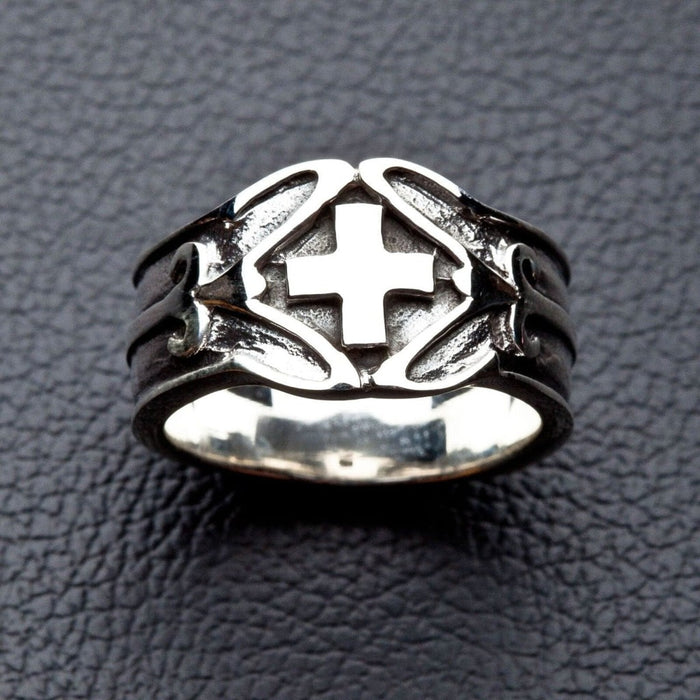 Detailed close-up of Celtic Cross ring on dark leather texture
