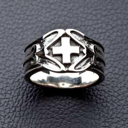 Detailed close-up of Celtic Cross ring on dark leather texture