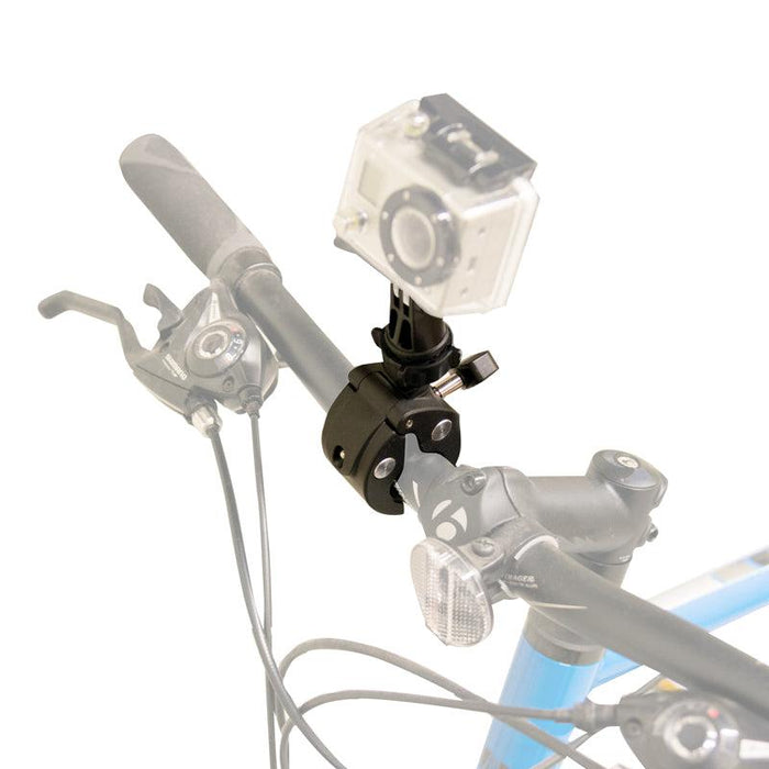 A close-up of a bicycle handlebar shows an action camera attached with the Clamp Mount with GoPro Mount, along with gear shifters, brake levers, and a small front light.