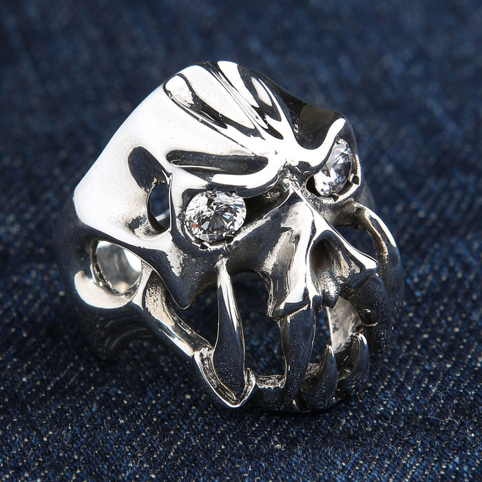 An angled view of the gothic biker ring, highlighting the huge polished fangs and sparkling clear eyes.