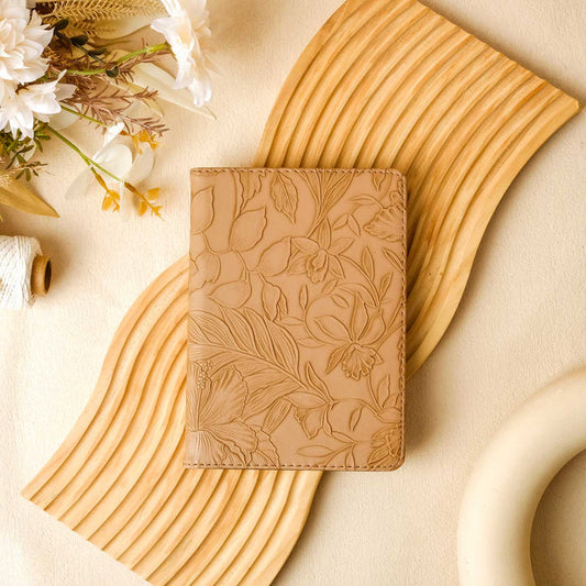 A tan floral pattern Kindle case displayed on a neutral background, with a magnet visible on the back.
