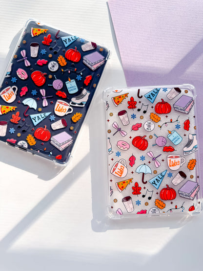 Two Kindle cases withGilmore Girls themed designs, one with a dark background and one with a light background, both featuring various cartoon-style illustrations related to the show.