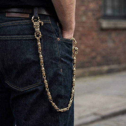 Gothic skull brass wallet chain worn on dark denim jeans showing drape and fit