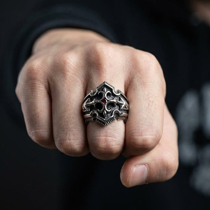 Man wearing gothic shield sterling silver ring with garnet CZ stone on middle finger showing fist pose
