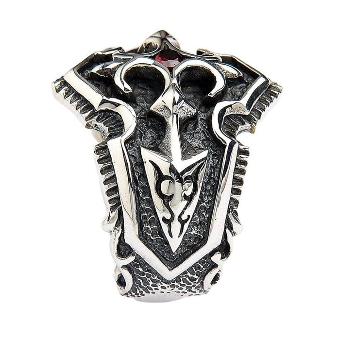 Top down view of sterling silver medieval shield ring displaying symmetrical Gothic pattern and red gemstone