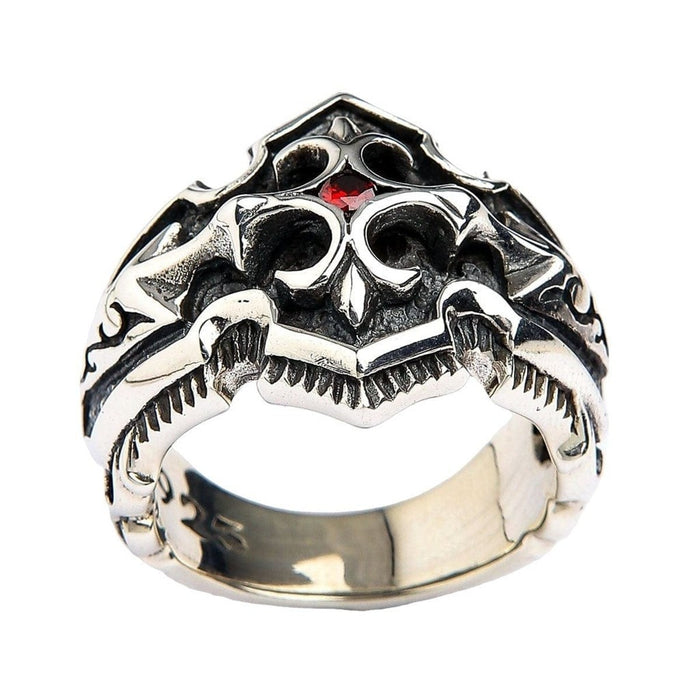 Artisan crafted silver ring front face showing fleur-de-lis motif surrounding deep red garnet cubic zirconia