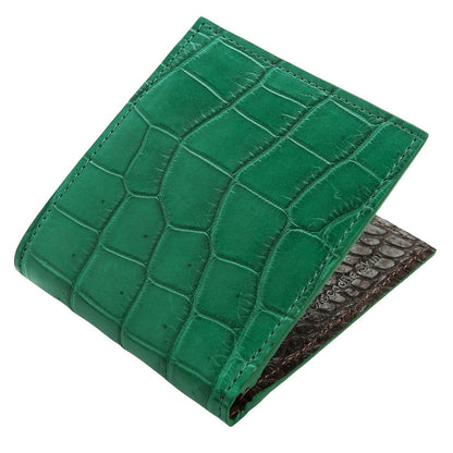 Angled view of the green crocodile leather wallet showing its bifold design and contrasting black interior.