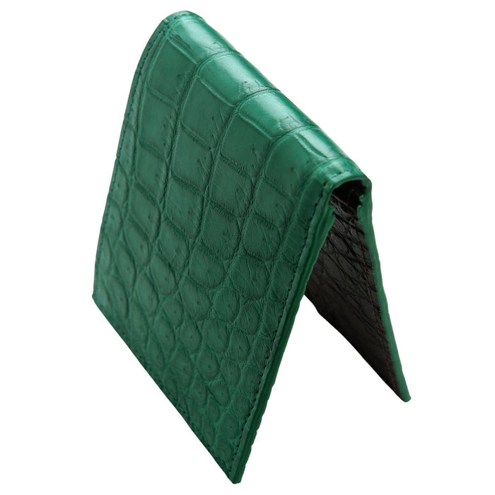 A side profile view of the closed green crocodile bifold wallet.