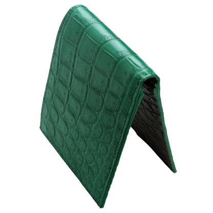 A side profile view of the closed green crocodile bifold wallet.