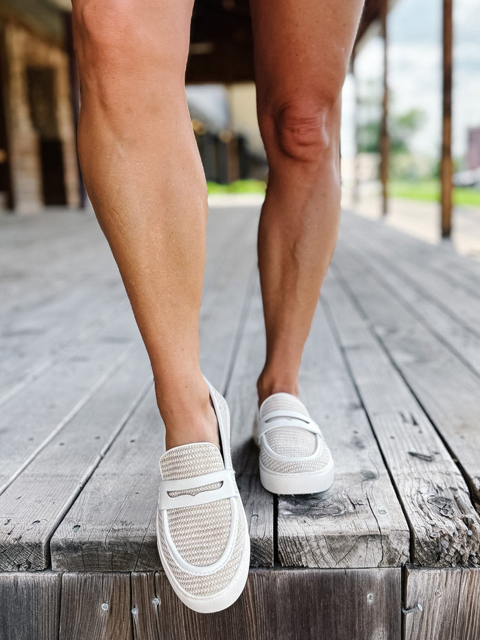 White combo slip-on loafers with breathable woven upper and leather accents.