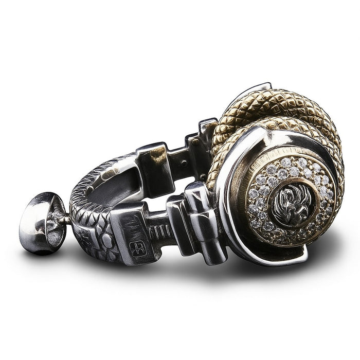 An angled view of the two-tone headphone pendant, highlighting the CZ diamond accents and Rasta lion.