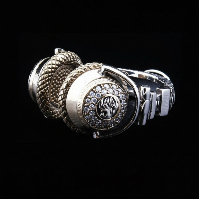 A side profile of the silver and gold DJ headphone pendant, showing the textured gold earcup.