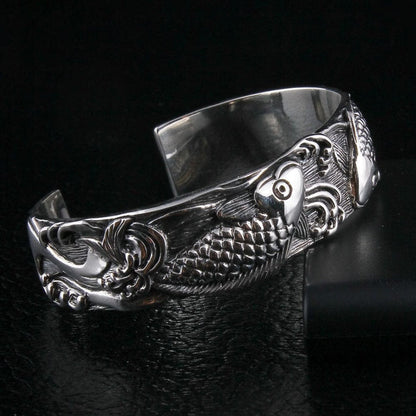 Handcrafted koi fish sterling silver cuff bracelet side angle with wave pattern details