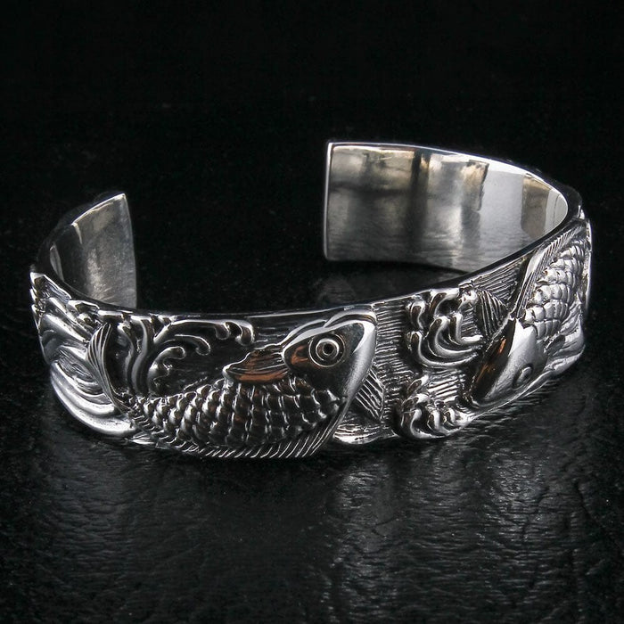 Koi fish silver cuff bracelet back view with flowing tail and wave motifs