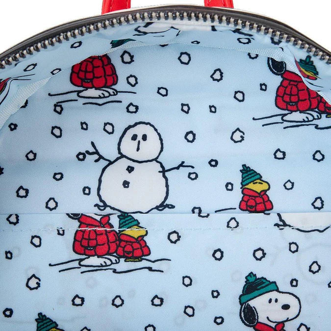 Close-up of a backpack with winter-themed designs featuring cartoon characters and snowflakes.