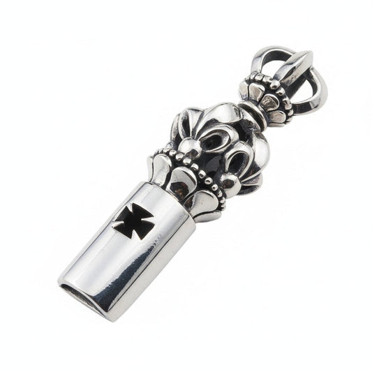 A handcrafted sterling silver medieval whistle pendant with a gothic crown top and an iron cross cutout, shown at an angle.