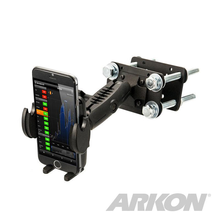 The Mega Grip™ Forklift Front Guard Mount is a black adjustable rugged phone holder with bolts, securely holding a smartphone displaying a graph. The ARKON logo appears in the bottom right corner.