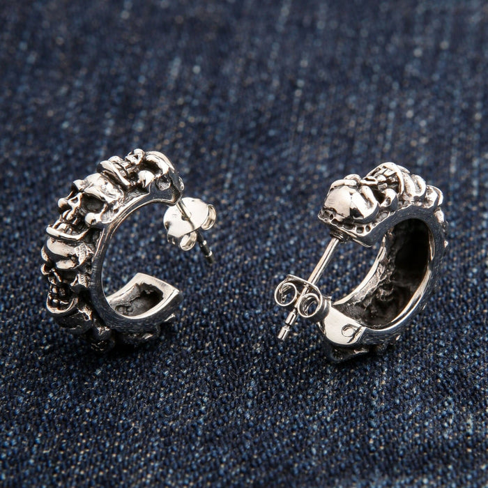 A side profile of the gothic skull hoop earrings, showing the intricate, three-dimensional skull details.