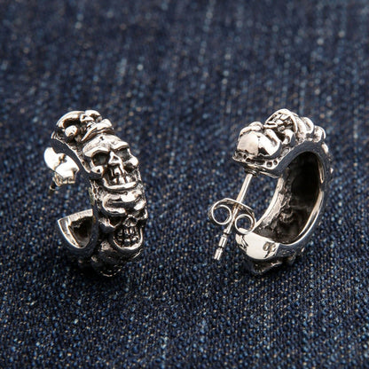 An angled view of the biker skull jewelry hoop earrings, highlighting the oxidized and polished finish.