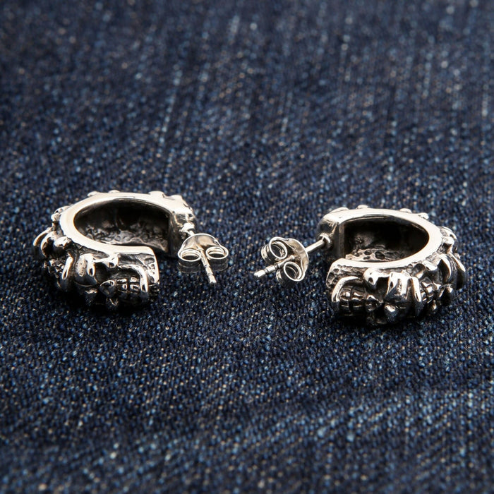 The back of the silver skull hoop earrings, showing the post and clutch backings