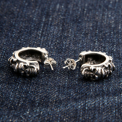 The back of the silver skull hoop earrings, showing the post and clutch backings