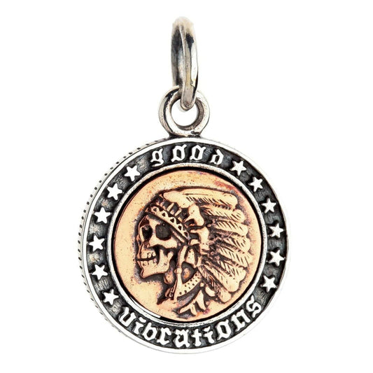A front view of the copper and silver Indian skull pendant, isolated on a white background.