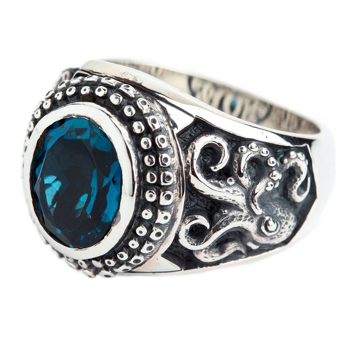 A nautical-themed Kraken ring for men, handcrafted from oxidized silver with a deep blue topaz stone.