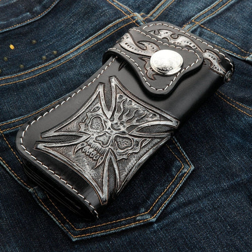 A premium, hand-tooled leather biker wallet featuring a unique phantom skull that seamlessly blends into a powerful Iron Cross.