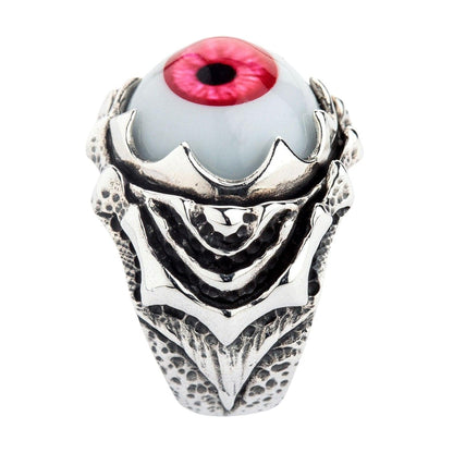 Direct view of the heavy sterling silver band, showcasing the layered, oxidized claw motif beneath the red polymer eye.