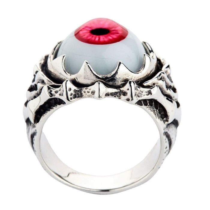 Standing upright, the ring reveals a smooth silver interior band beneath the bone-textured claws and red polymer eyeball.