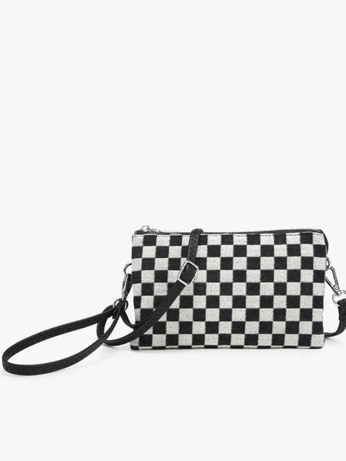 A small black and white checkered crossbody clutch bag with a black wrist strap and silver-tone hardware, shown against a plain white background.