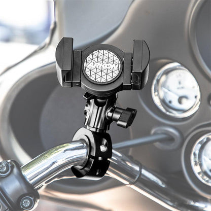 A RoadVise® XL Premium Aluminum Motorcycle Handlebar Phone and Midsize Tablet Mount in black is attached to the chrome handlebar, with the motorcycle’s dashboard and gauges visible in the blurred background.