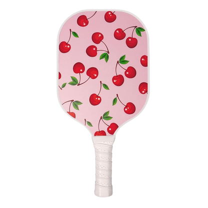 Front view of Single Pickleball Paddle, Cherry on Top print, showcasing pink cherry pattern and white wrapped grip on black background