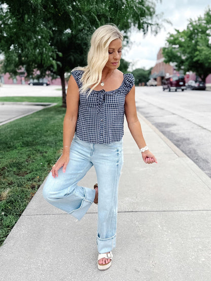 Light wash wide leg jeans with super a high-rise waist and oversized cuffed hems.