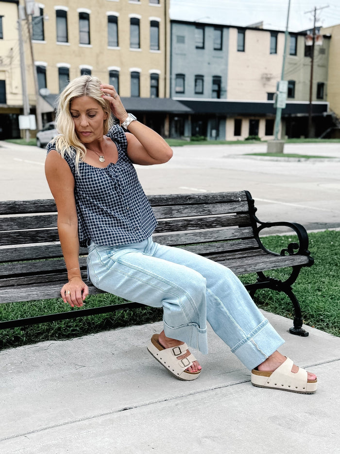 Light wash wide leg jeans with super a high-rise waist and oversized cuffed hems.