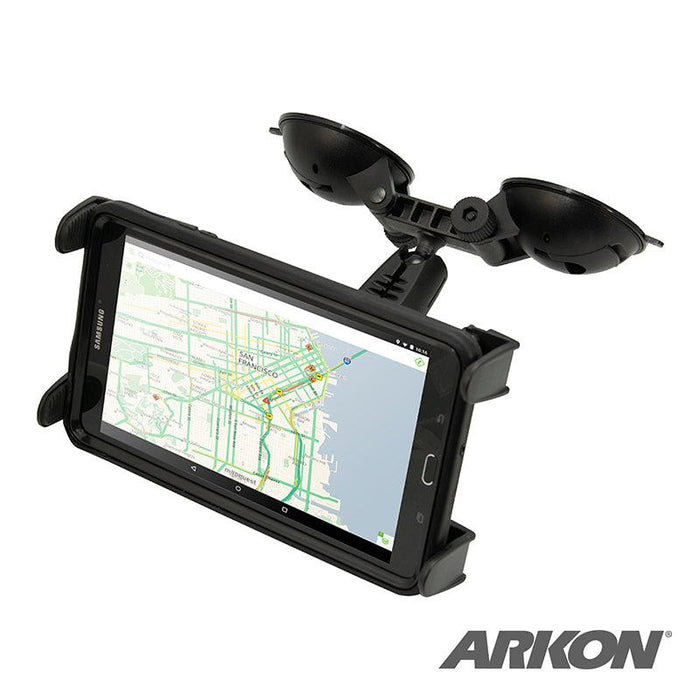 A smartphone with a map is mounted horizontally in the Slim-Grip® Double Suction Windshield Tablet Mount, which is securely attached above and features the ARKON logo in the bottom right corner.
