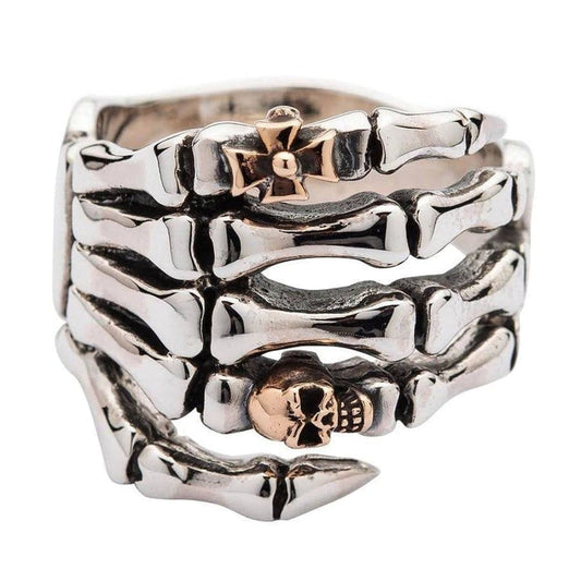 Sterling silver skeleton hand ring with rose gold skull and gothic cross front view on white background