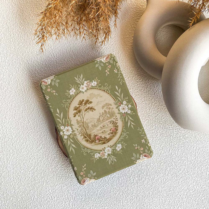 Decorative kindle case notebook with floral design on a textured surface