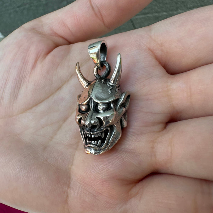 An alternative angle of the gothic Hannya mask style pendant, emphasizing the two-tone finish.