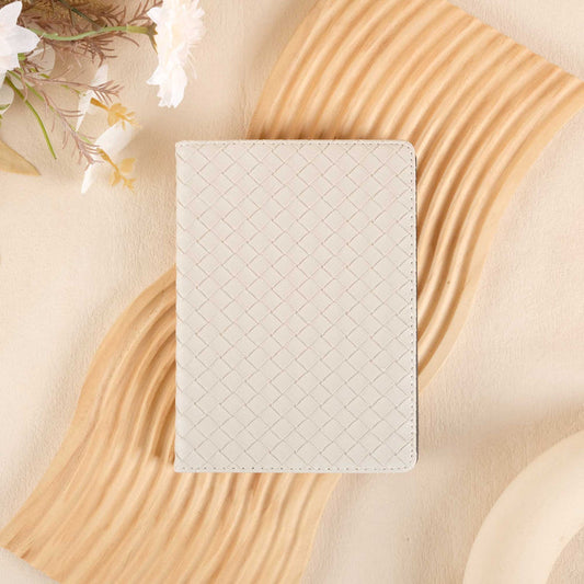 White woven kindle case on a beige surface with floral elements